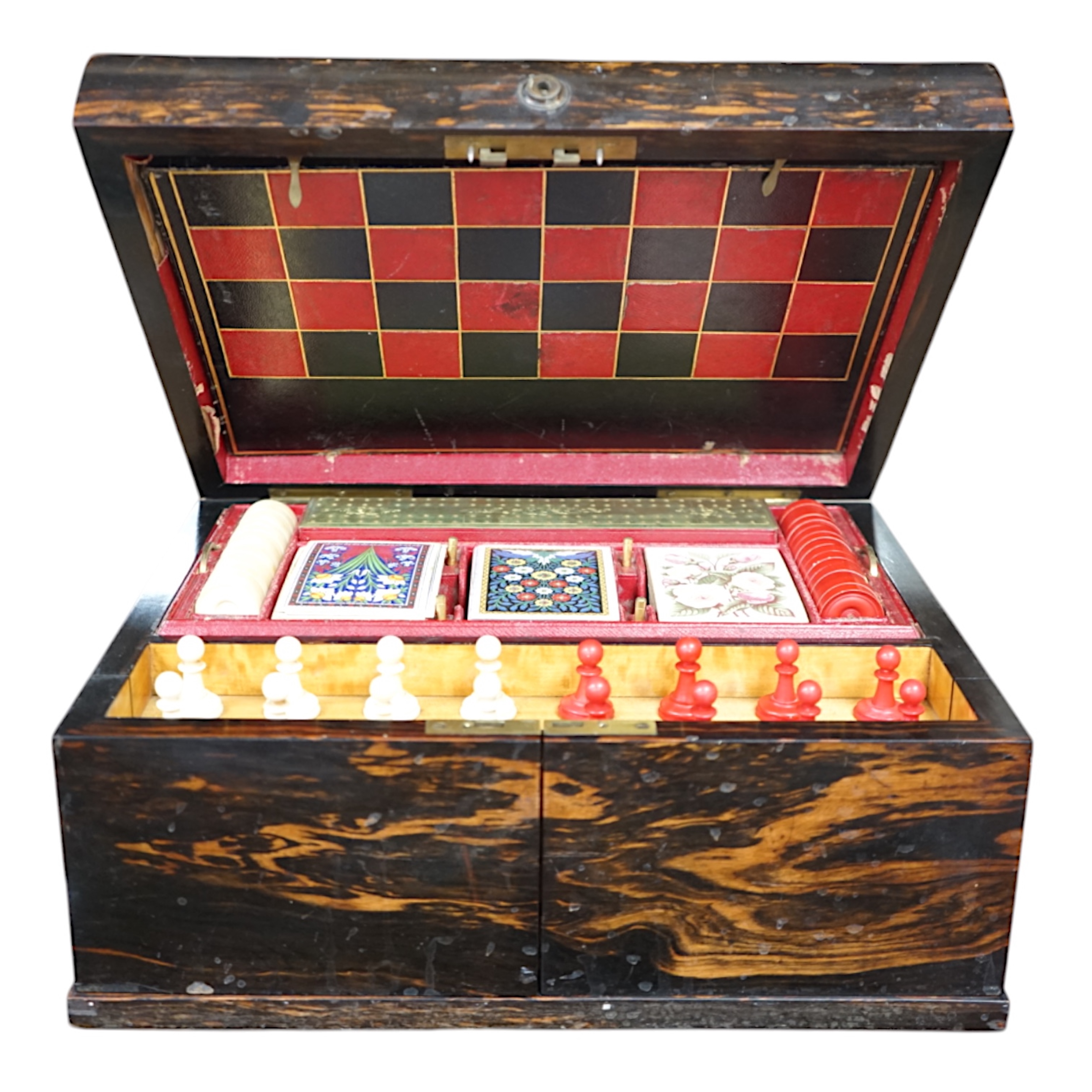 A Victorian coromandel games box with accessories, ivory chess pieces and counters, box 36cm wide x 19cm high. Condition - red interior leather worn and torn in places and box scratched, minor losses to chess pieces. CIT